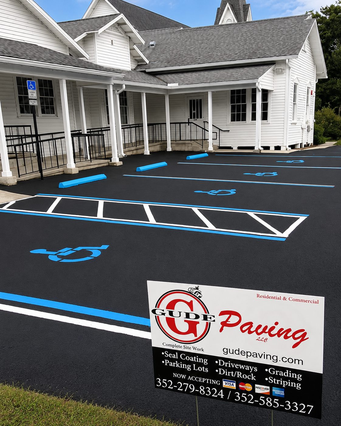 Freshly sealcoated parking lot with new ADA striping and blue curb stops
